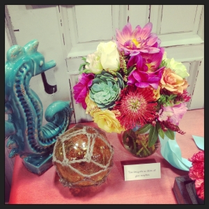 Coral and turquoise centerpieces for a wedding.