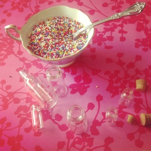 Fill a cup, or bowl,  with the sprinkles, so that you can fill the jars over the receptacle. It makes this slightly less messy. 